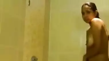 Indian girl takes her clothes off and gets into the shower stall for some porn