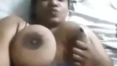 Desi charmer fools around in bed with XXX sized breasts naked in MMS